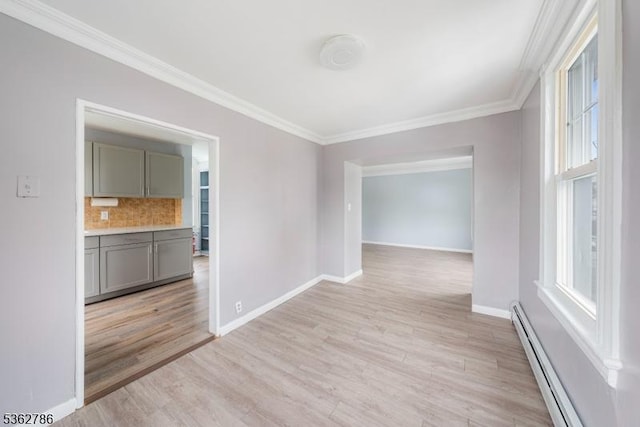 90 Thomas St, Bloomfield Twp, NJ 07003 - empty room with a baseboard heating unit, ornamental molding, healthy amount of natural light, and light wood-type flooring