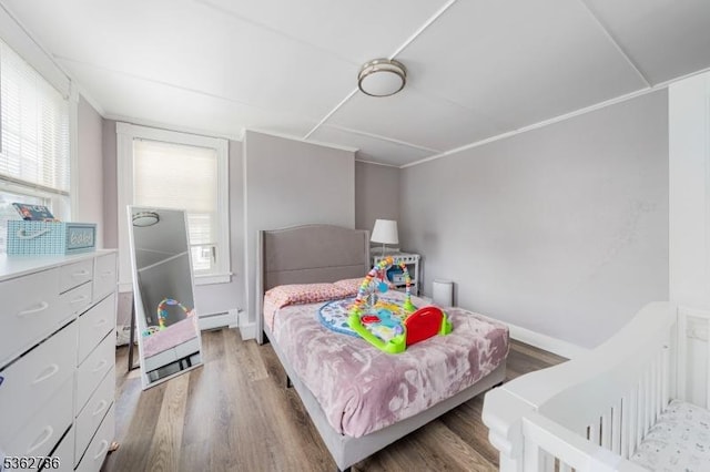 90 Thomas St, Bloomfield Twp, NJ 07003 - bedroom with light wood-style flooring and a baseboard heating unit