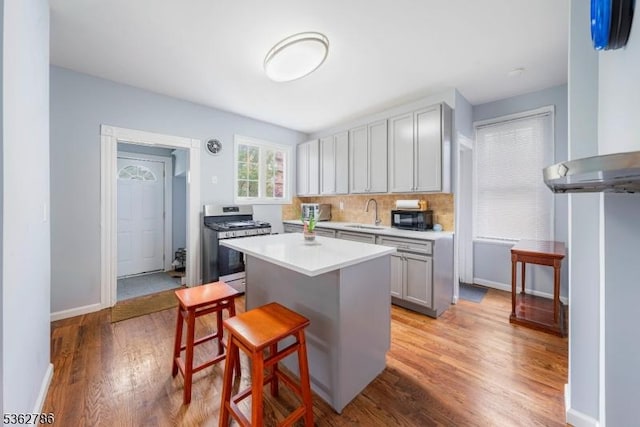 90 Thomas St, Bloomfield Twp, NJ 07003 - kitchen featuring gas range, a kitchen bar, black microwave, a center island, and light countertops