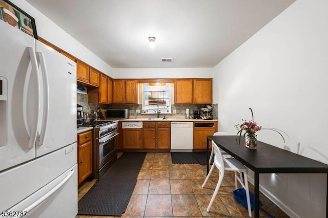303-305 W Runyon St, Newark City, NJ 07108 - kitchen featuring stainless steel appliances, backsplash, brown cabinets, and light countertops