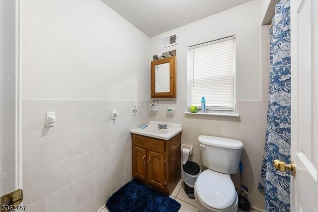 303-305 W Runyon St, Newark City, NJ 07108 - bathroom with vanity, toilet, tile walls, wainscoting, and a shower with shower curtain