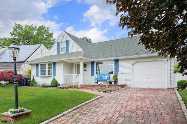 223 E Ln, Clark Twp, NJ 07066 - view of front of house with covered porch, an attached garage, decorative driveway, and a front yard