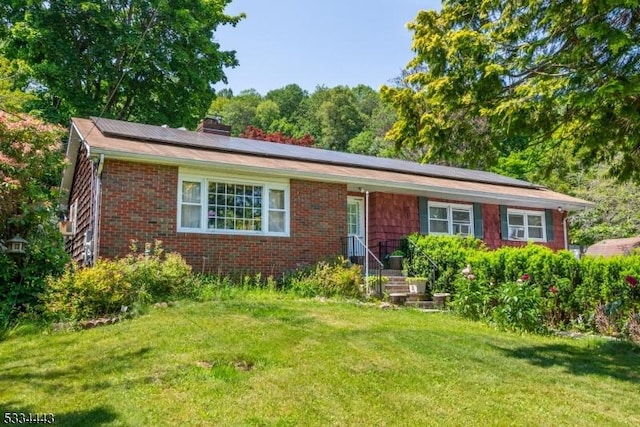 138 Bartley Flanders Rd, Mount Olive Twp, NJ 07836 - single story home featuring roof mounted solar panels, a front yard, a chimney, and brick siding