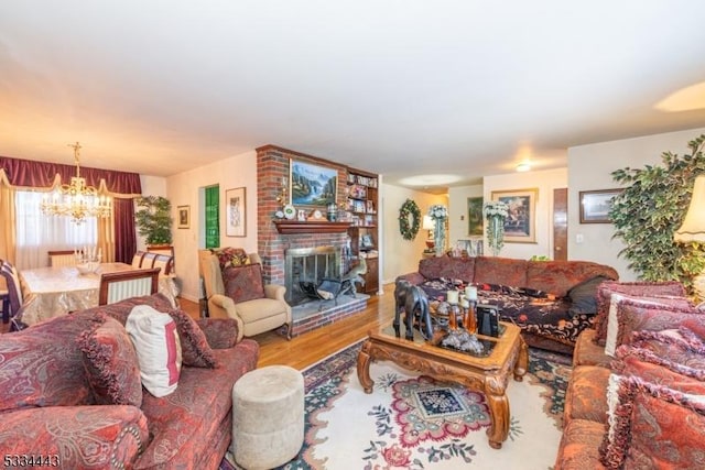 138 Bartley Flanders Rd, Mount Olive Twp, NJ 07836 - living room featuring a chandelier, wood finished floors, and a brick fireplace