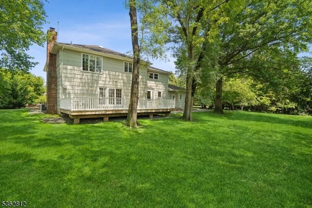 8 Debra Ct, Scotch Plains Twp, NJ 07076 - back of house featuring a chimney, a deck, a lawn, and central air condition unit
