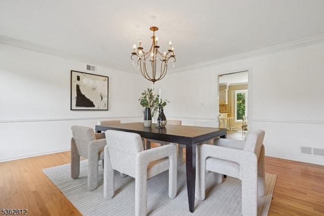 8 Debra Ct, Scotch Plains Twp, NJ 07076 - dining area with a chandelier, crown molding, and light wood-style flooring