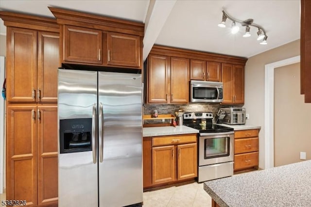 13 Oklahoma Trl, Hopatcong Boro, NJ 07843 - kitchen with stainless steel appliances, tasteful backsplash, brown cabinets, light countertops, and light tile patterned floors