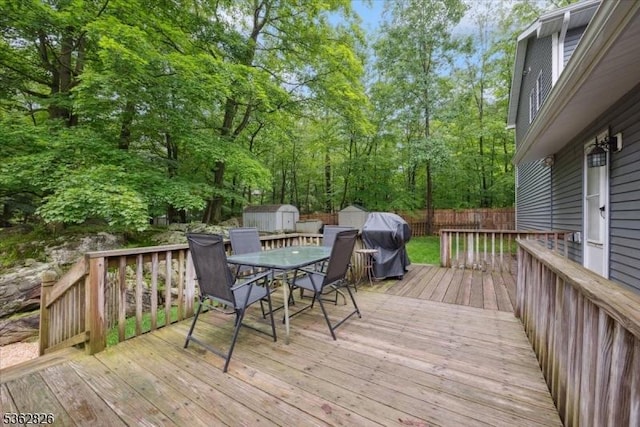 13 Oklahoma Trl, Hopatcong Boro, NJ 07843 - wooden terrace with a storage unit, outdoor dining area, a grill, and a fenced backyard