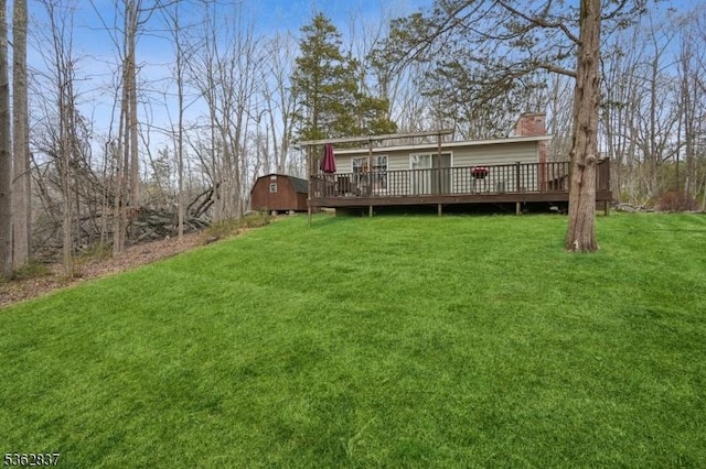 907 Meadowbrook Rd, Stillwater Twp, NJ 07860 - rear view of property featuring a wooden deck, a yard, and a chimney