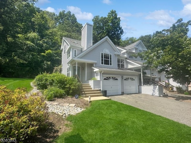 51 Rushmore Ln, Allamuchy Twp, NJ 07840 - view of front facade with an attached garage, asphalt driveway, a front lawn, and a chimney