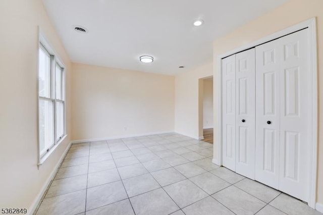 145 S Arlington Ave Unit C, East Orange City, NJ 07018 - unfurnished bedroom with a closet, baseboards, light tile patterned floors, and recessed lighting