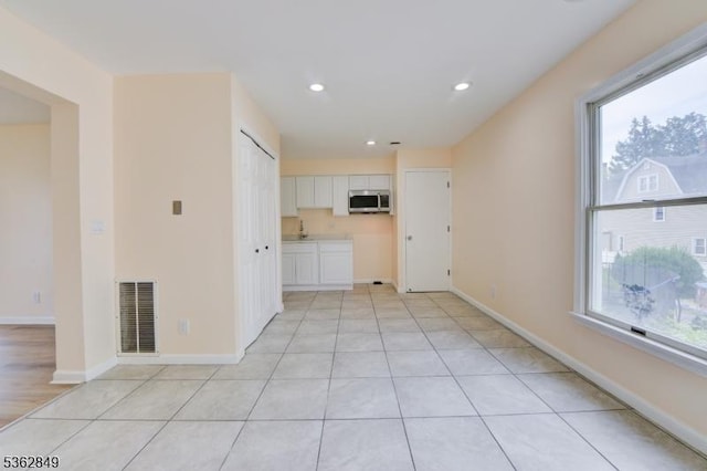 145 S Arlington Ave Unit C, East Orange City, NJ 07018 - unfurnished living room featuring recessed lighting, baseboards, a sink, and light tile patterned floors
