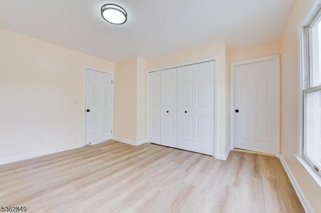 145 S Arlington Ave Unit C, East Orange City, NJ 07018 - unfurnished bedroom with light wood-style floors, multiple windows, and a closet