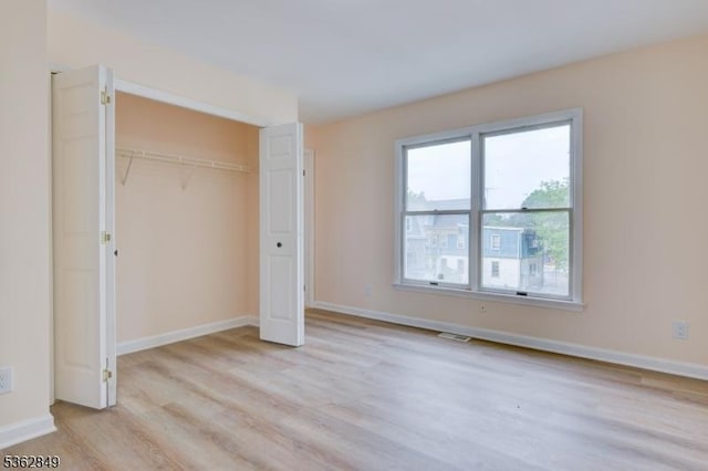 145 S Arlington Ave Unit C, East Orange City, NJ 07018 - unfurnished bedroom with light wood finished floors, baseboards, and a closet