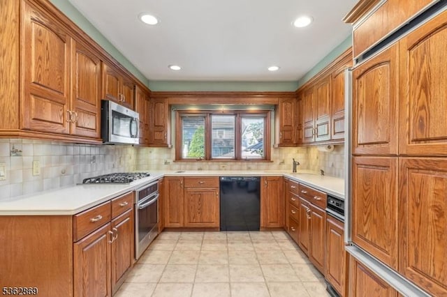 219 Elm Ct, Scotch Plains Twp, NJ 07076 - kitchen with stainless steel appliances, brown cabinetry, backsplash, light countertops, and recessed lighting