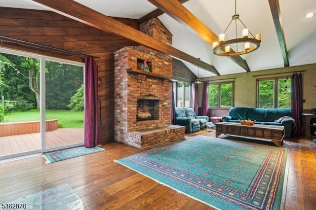 261 Brooklake Rd, Florham Park Boro, NJ 07932 - living room featuring a chandelier, wood-type flooring, a brick fireplace, and wood walls