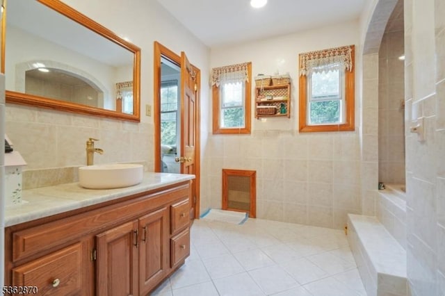 261 Brooklake Rd, Florham Park Boro, NJ 07932 - bathroom featuring tile walls, healthy amount of natural light, vanity, tile patterned floors, and a tub