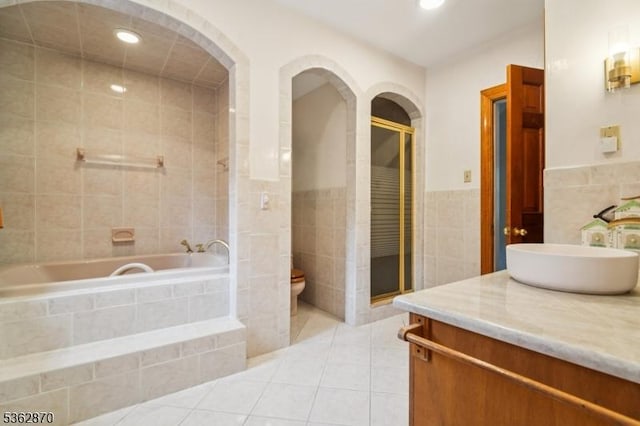 261 Brooklake Rd, Florham Park Boro, NJ 07932 - bathroom with tile walls, vanity, toilet, tile patterned floors, and tiled shower