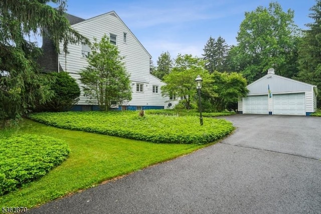 261 Brooklake Rd, Florham Park Boro, NJ 07932 - view of property exterior with a detached garage, an outbuilding, and a lawn