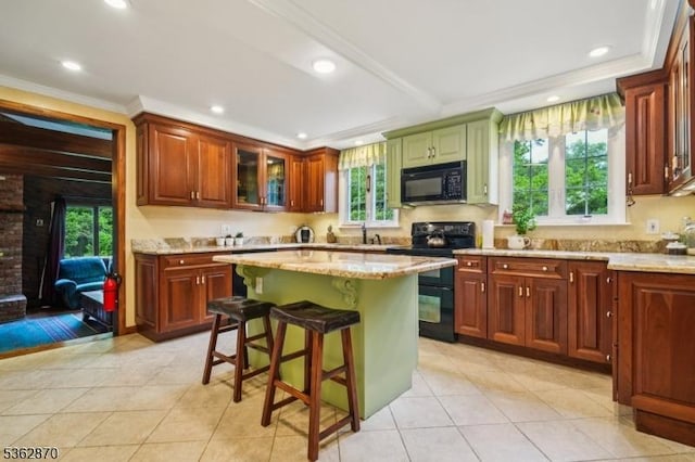 261 Brooklake Rd, Florham Park Boro, NJ 07932 - kitchen with black appliances, a breakfast bar, light tile patterned floors, light stone counters, and a center island