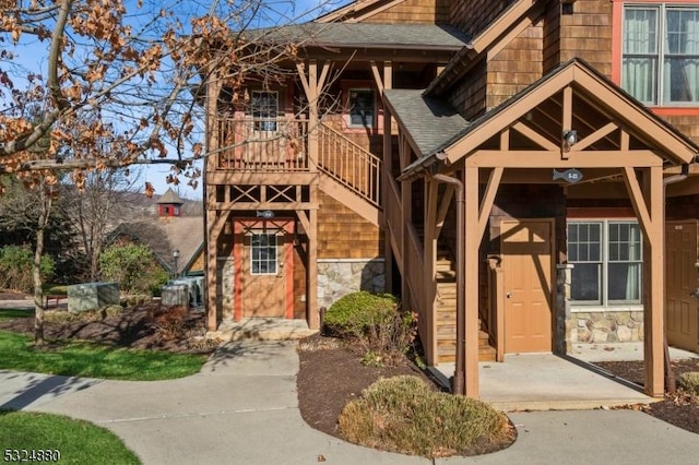 5 Pine Cres Unit 11, Vernon Twp, NJ 07462 - view of front of property with stairway, stone siding, and a shingled roof