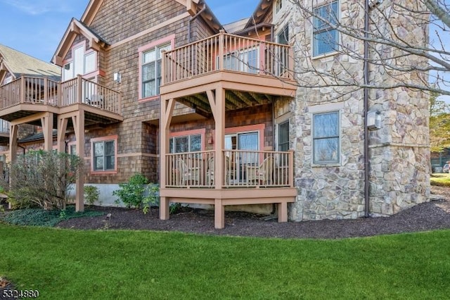 5 Pine Cres Unit 11, Vernon Twp, NJ 07462 - rear view of house with a balcony, a yard, and stone siding
