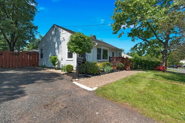 38 Hawthorne Dr, Franklin Twp, NJ 08873 - view of front of home featuring a chimney, driveway, and a wooden deck