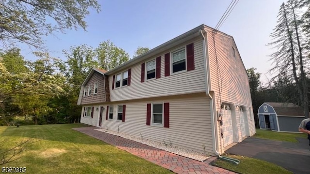 89 Mackerley Rd, Green Twp, NJ 07860 - rear view of property featuring a garage, asphalt driveway, and a yard