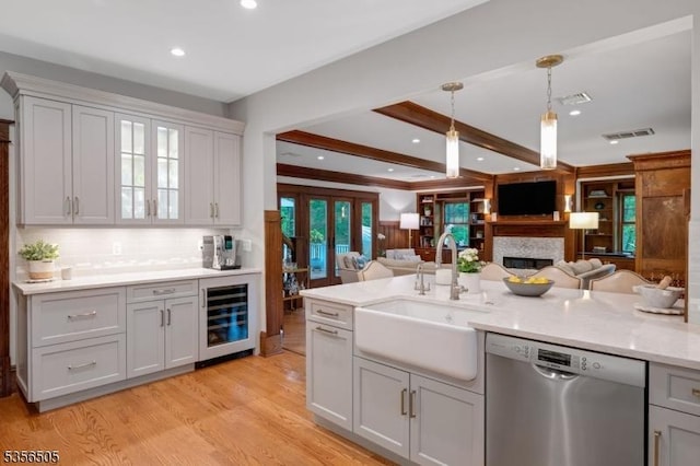 34 Crane Rd, Mountain Lakes Boro, NJ 07046 - kitchen featuring stainless steel dishwasher, a sink, beverage cooler, open floor plan, and light wood-style floors