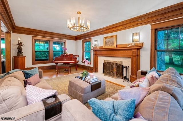 34 Crane Rd, Mountain Lakes Boro, NJ 07046 - living area featuring a chandelier, wood finished floors, ornamental molding, a fireplace, and healthy amount of natural light