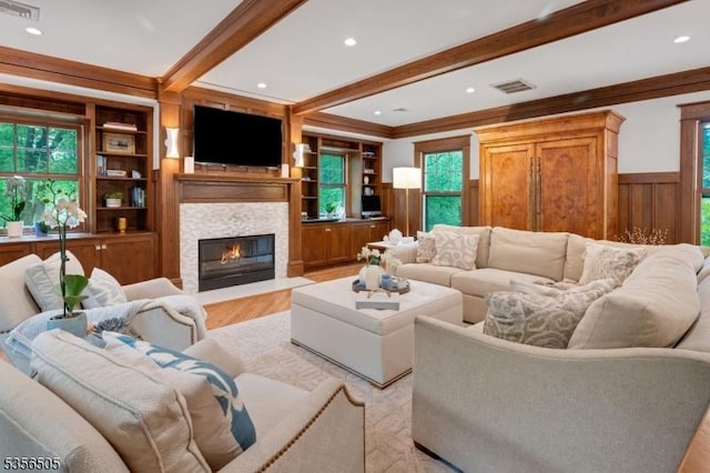 34 Crane Rd, Mountain Lakes Boro, NJ 07046 - living room with beam ceiling, a fireplace with flush hearth, a wainscoted wall, light wood finished floors, and ornamental molding