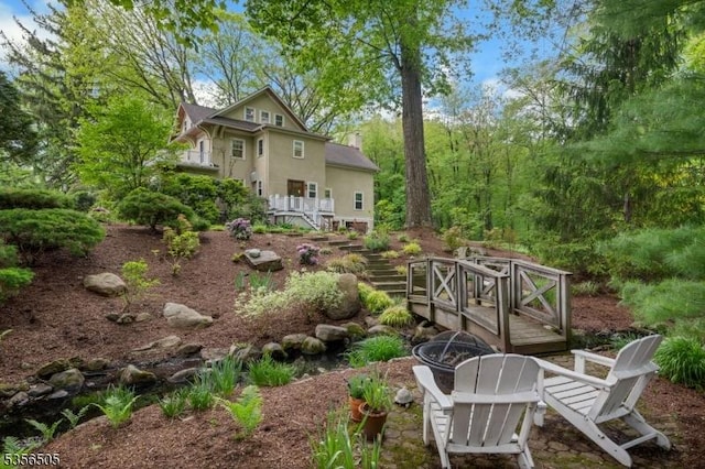 34 Crane Rd, Mountain Lakes Boro, NJ 07046 - rear view of property with stairs, a fire pit, a wooden deck, and stucco siding