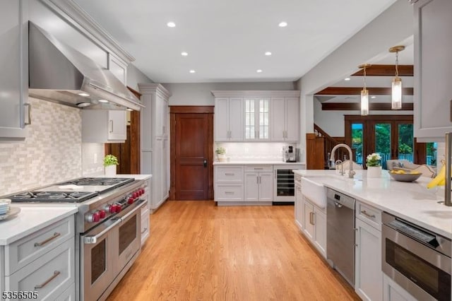 34 Crane Rd, Mountain Lakes Boro, NJ 07046 - kitchen featuring stainless steel appliances, wall chimney exhaust hood, recessed lighting, tasteful backsplash, and a sink
