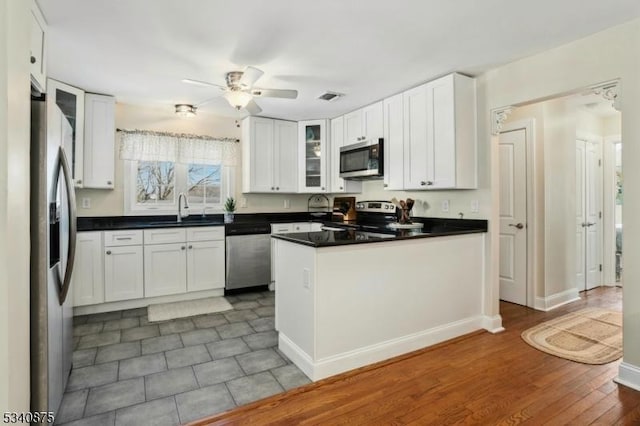 42 Stehr St, Frankford Twp, NJ 07826 - kitchen with stainless steel appliances, a sink, a ceiling fan, white cabinetry, and dark countertops