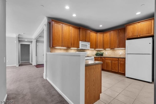 1206 Conrad Way, Franklin Twp, NJ 08873 - kitchen with white appliances, decorative backsplash, recessed lighting, brown cabinetry, and a peninsula