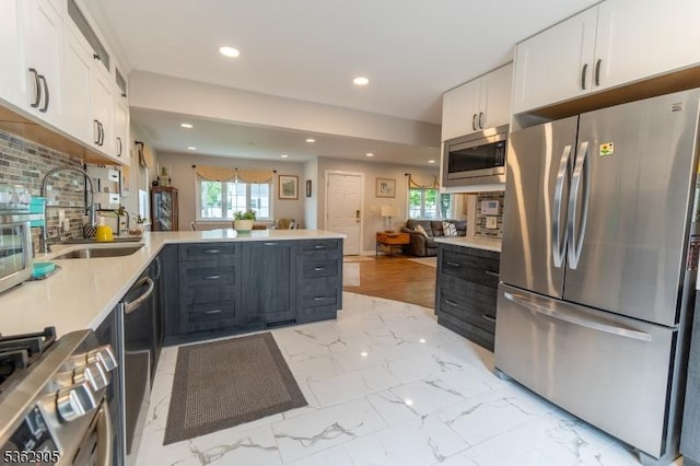 550 Melrose Ave, South Plainfield Boro, NJ 07080 - kitchen with appliances with stainless steel finishes, a sink, white cabinets, a peninsula, and recessed lighting