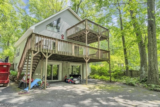 72 Quenby Mountain Rd, Liberty Twp, NJ 07838 - back of property with a deck, stairway, a carport, and driveway