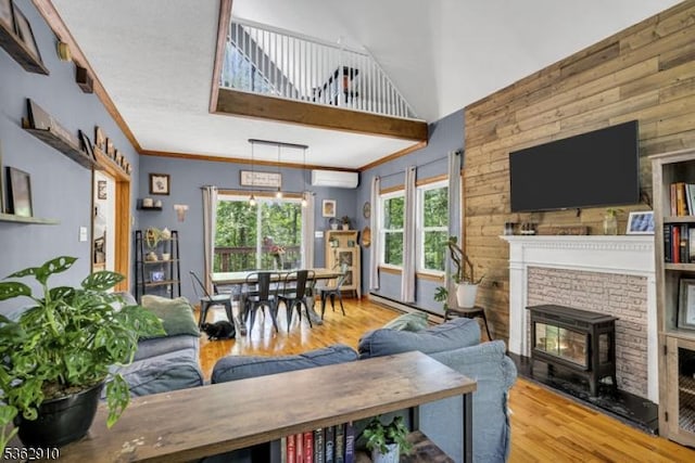 72 Quenby Mountain Rd, Liberty Twp, NJ 07838 - living area with wood finished floors, a wall mounted air conditioner, a wood stove, wooden walls, and a high ceiling