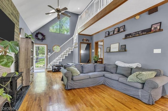 72 Quenby Mountain Rd, Liberty Twp, NJ 07838 - living area featuring stairs, high vaulted ceiling, a wood stove, hardwood / wood-style flooring, and a ceiling fan