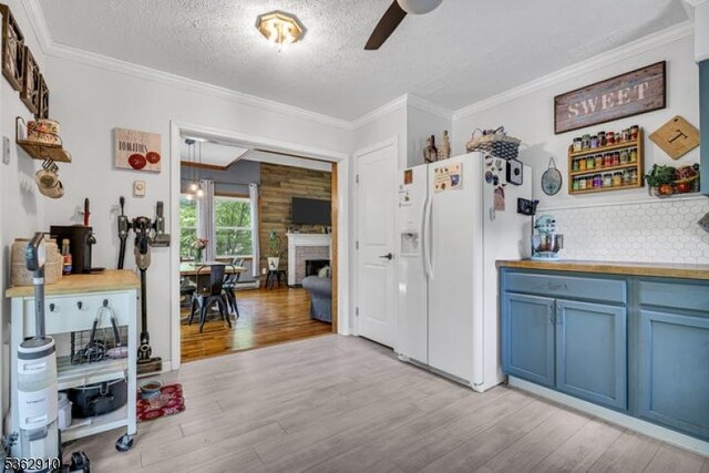 72 Quenby Mountain Rd, Liberty Twp, NJ 07838 - kitchen featuring blue cabinets, white refrigerator with ice dispenser, light wood finished floors, a textured ceiling, and ornamental molding