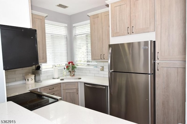 97 Wescott Rd, Bedminster Twp, NJ 07921 - kitchen with stainless steel appliances, light brown cabinetry, backsplash, light countertops, and a sink