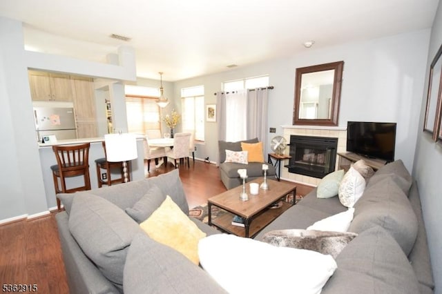 97 Wescott Rd, Bedminster Twp, NJ 07921 - living room with wood finished floors, a tile fireplace, and baseboards