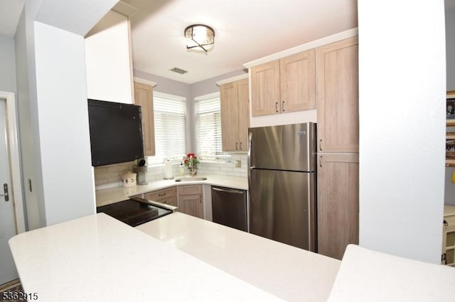 97 Wescott Rd, Bedminster Twp, NJ 07921 - kitchen featuring stainless steel appliances, light brown cabinetry, light countertops, and decorative backsplash