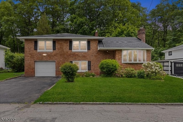 11 Amendola Dr, Netcong Boro, NJ 07857 - split level home with an attached garage, asphalt driveway, a chimney, and a front yard