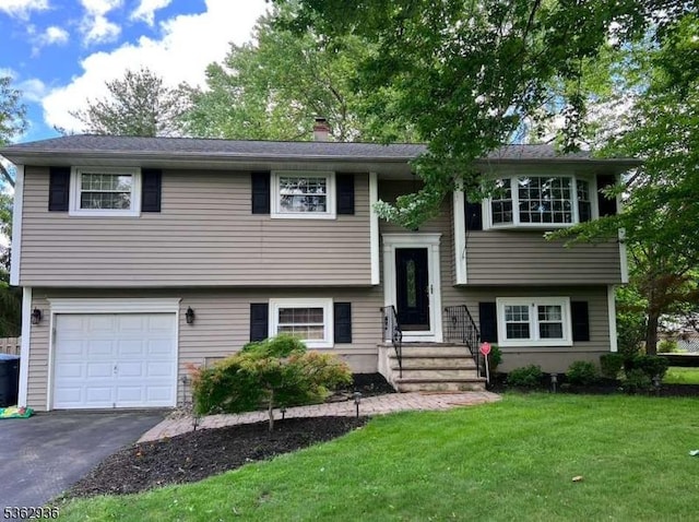10 Grandin Dr, Raritan Twp, NJ 08822 - raised ranch featuring an attached garage, a front yard, a chimney, and driveway