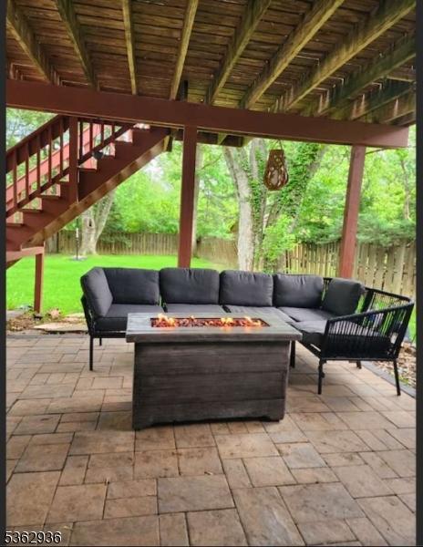 10 Grandin Dr, Raritan Twp, NJ 08822 - fenced backyard with an outdoor living space with a fire pit, a patio area, and stairs