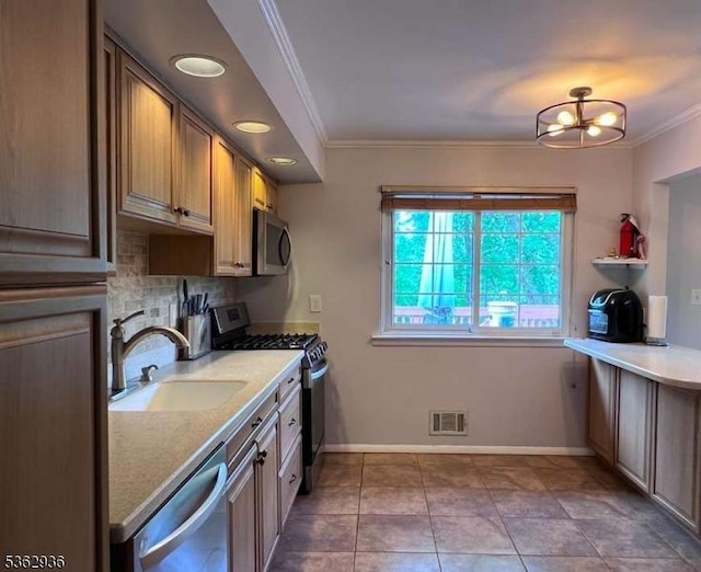 10 Grandin Dr, Raritan Twp, NJ 08822 - kitchen with appliances with stainless steel finishes, crown molding, a sink, light countertops, and baseboards