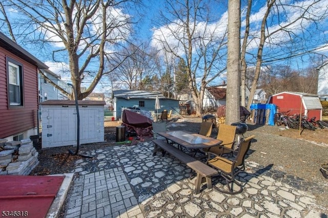 13 Franklin Pl, Wanaque Boro, NJ 07420 - view of patio featuring mail area, outdoor dining area, and a storage unit