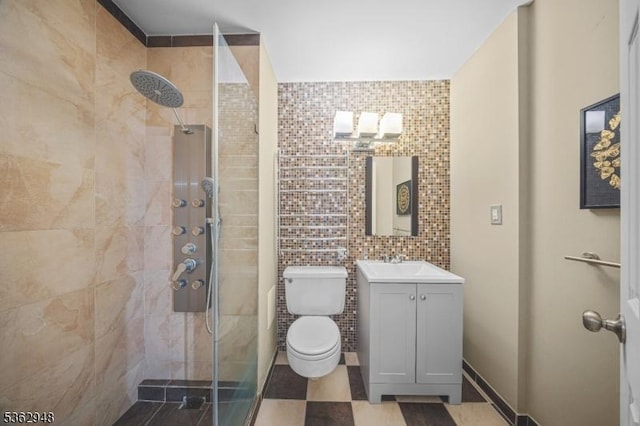 7002 Kennedy Blvd Unit 36G, Guttenberg Town, NJ 07093 - bathroom featuring vanity, a tile shower, toilet, and tile walls
