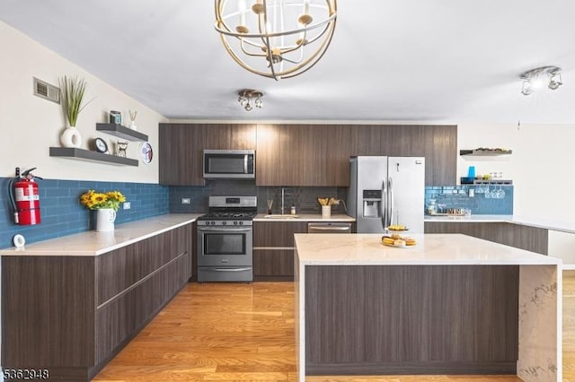 7002 Kennedy Blvd Unit 36G, Guttenberg Town, NJ 07093 - kitchen with open shelves, appliances with stainless steel finishes, a sink, light countertops, and decorative backsplash